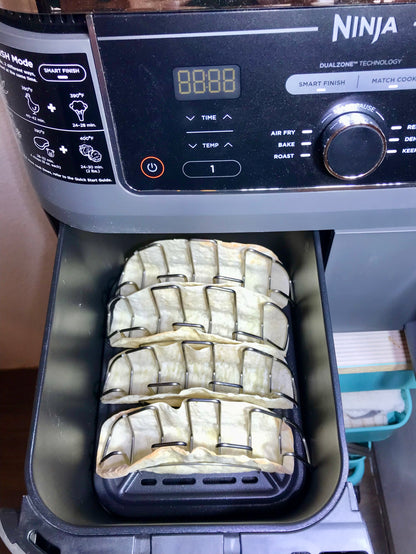 Mi Taco Stand taco stand in ninja air fryer making crunchy taco shells at home.